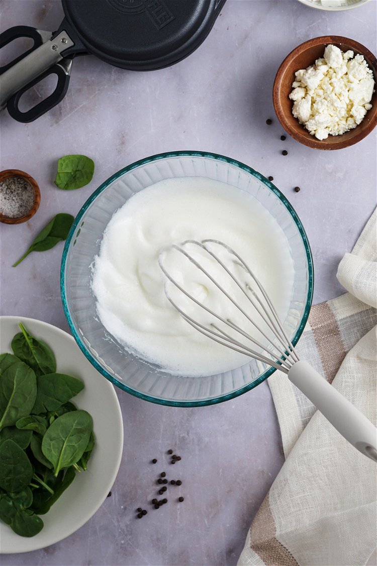 Image of In a large mixing bowl, whisk egg whites with an...