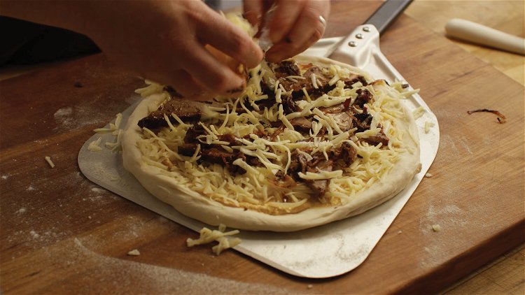 Image of To build the pizza, stretch one dough ball out thin....