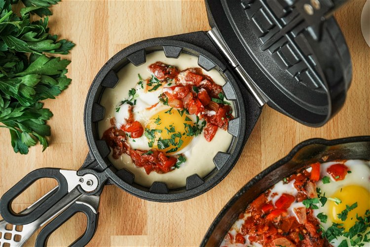 Image of Add the shakshuka filling and an egg.