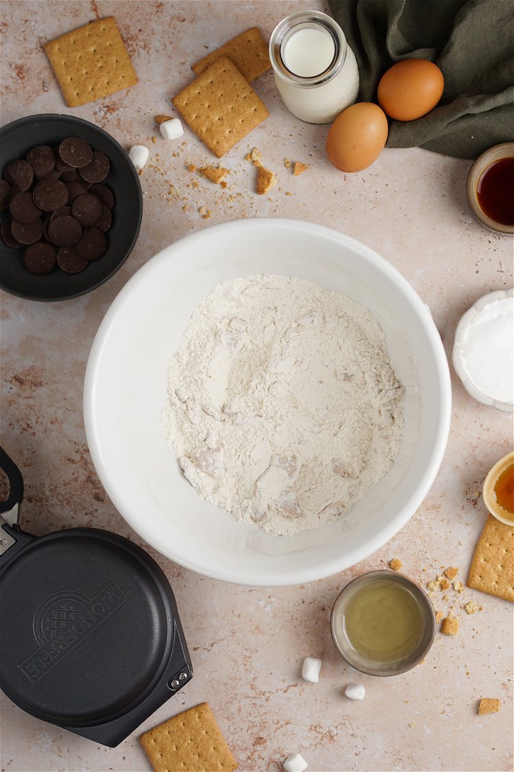 Image of In a large mixing bowl, combine flour, crushed graham crackers,...