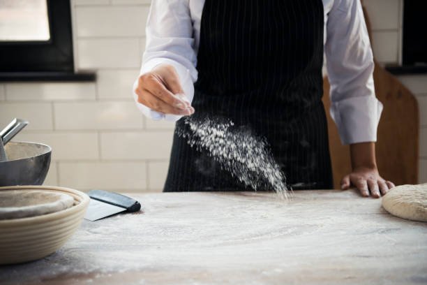 Image of Sprinkle counter and dust rolling pin with hard flour. Roll...