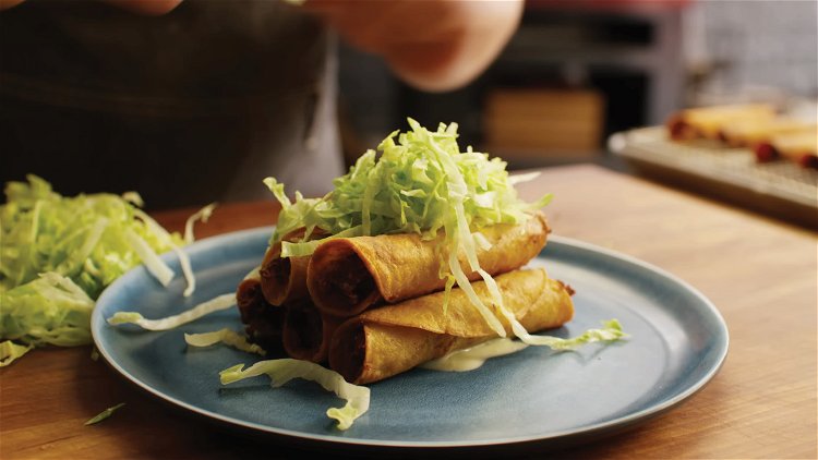 Image of Serve the taquitos topped with shredded lettuce, avocado crema, more...