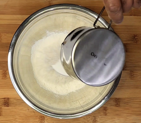 Image of In a large mixing bowl, whisk together the flour, sugar,...