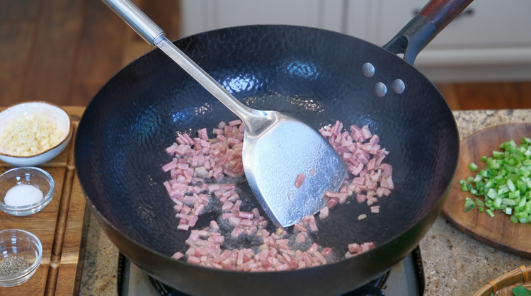 Image of Heat a wok over high heat. Add the pork lark and Jinhua ham and saute for 2 minutes. If using bacon as a replacement, please skip the pork lard, as you will get lots of fat.