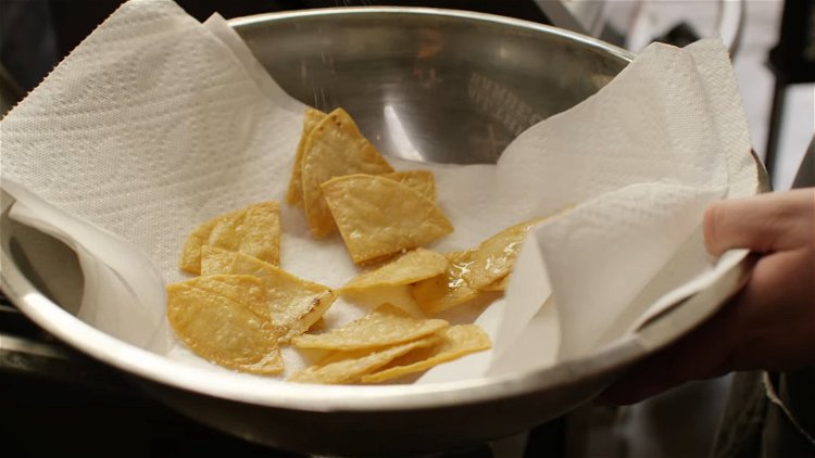 Image of To make the Totopos, cut the tortillas into quarters. Working...