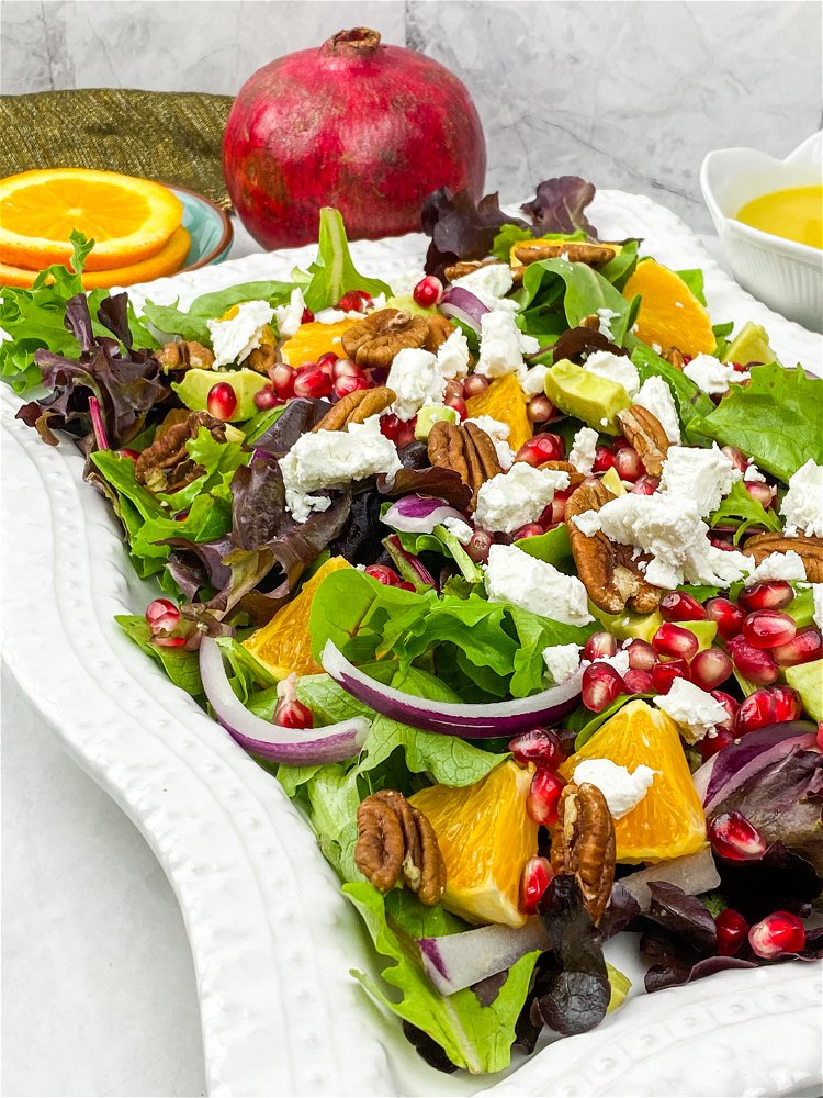 Image of Arrange the mixed greens on a large serving platter and...