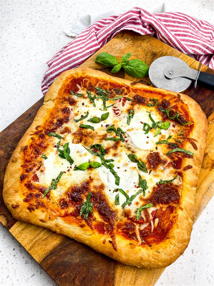 Image of To serve, carefully slide the baked pizza to a clean...