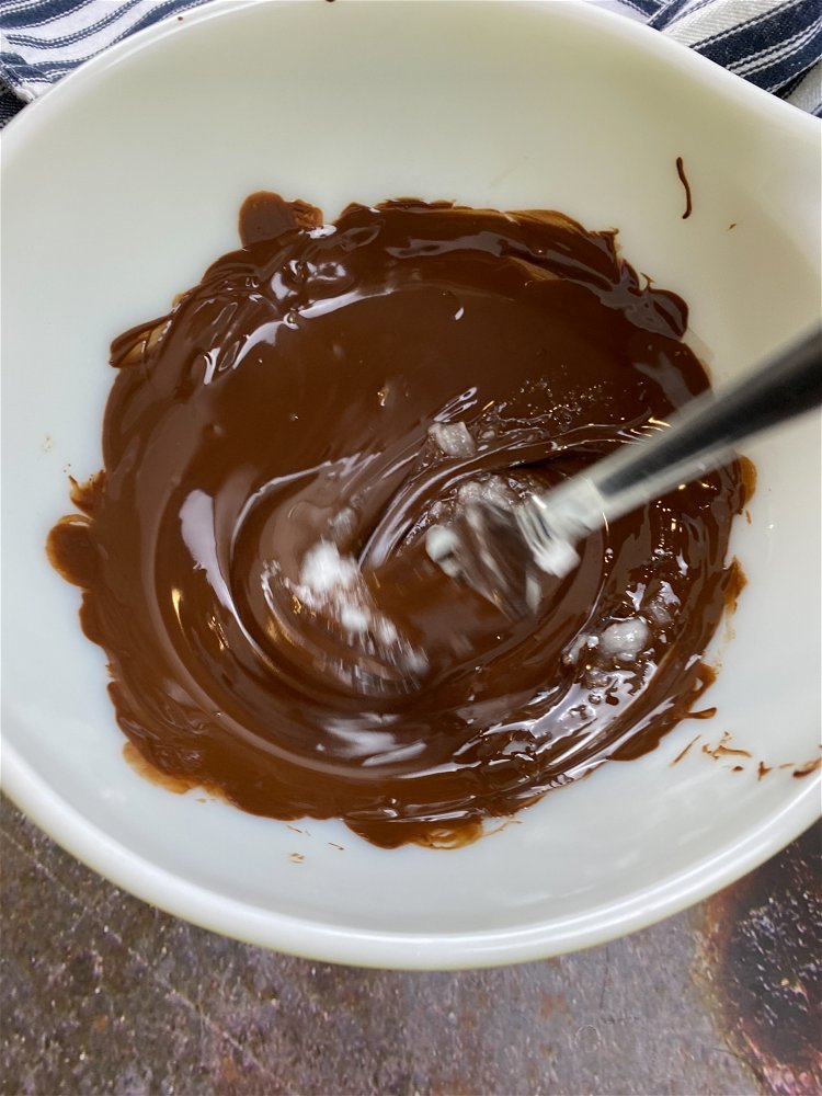 Image of Pour semi-sweet chocolate chips into a dry, microwave-safe bowl and...
