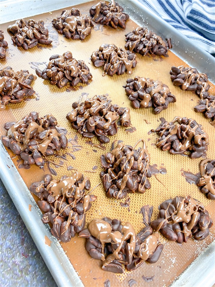 Image of Drizzle the melted milk chocolate over the peanut clusters and...