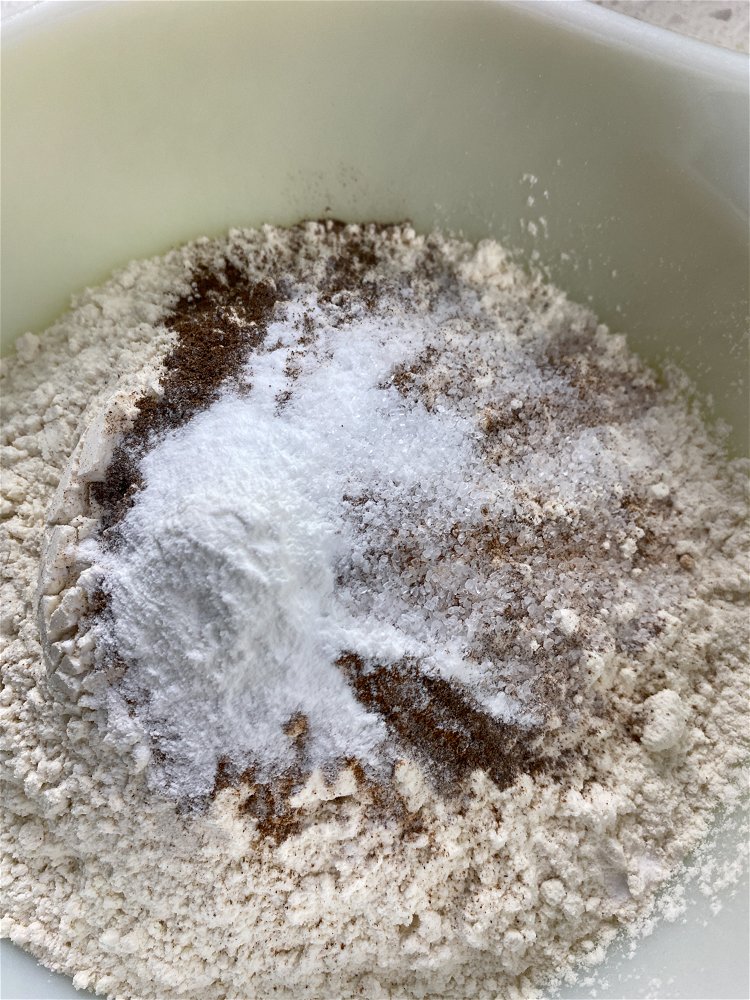 Image of Add the flour, cinnamon, allspice, baking soda, baking powder, and...