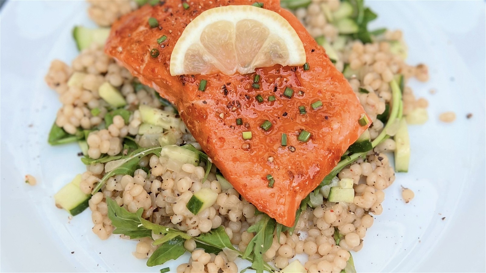 Image of Honey Harissa Glazed Salmon with Kitchen and Market Israeli Couscous Pilaf and Arugula