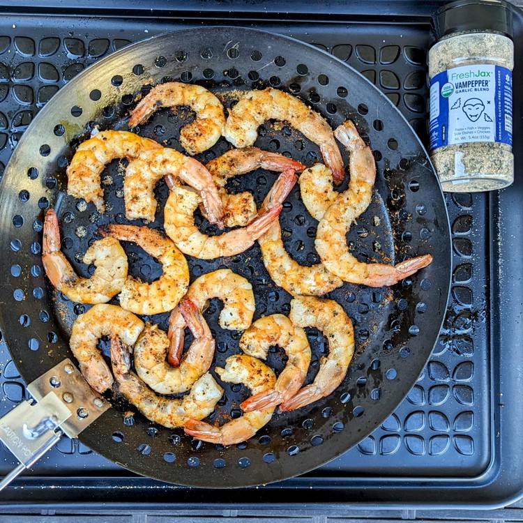 Image of Grill directly over medium-high heat with the lid open for 3-4 minutes a side to develop a char until the shrimp starts to lose its translucence, turning occasionally.