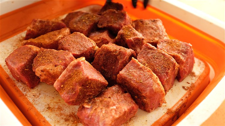 Image of Cut Brisket into 2” cubes. Slather your brisket cubes with...