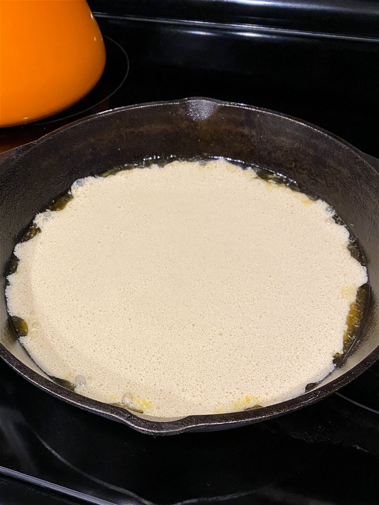 Image of Pour the blended batter into the center of the hot...