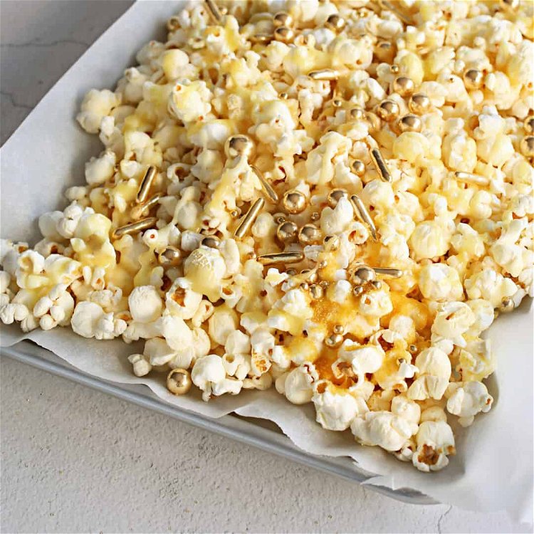 Image of Pop the popcorn, spread it out on a sheet pan...