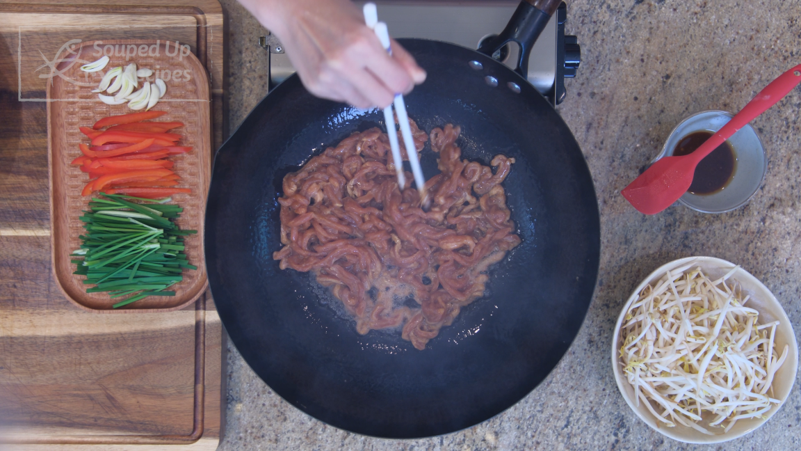 Image of Add pork lard and the pork. Stir over high heat for a couple of minutes or until the meat changes color.