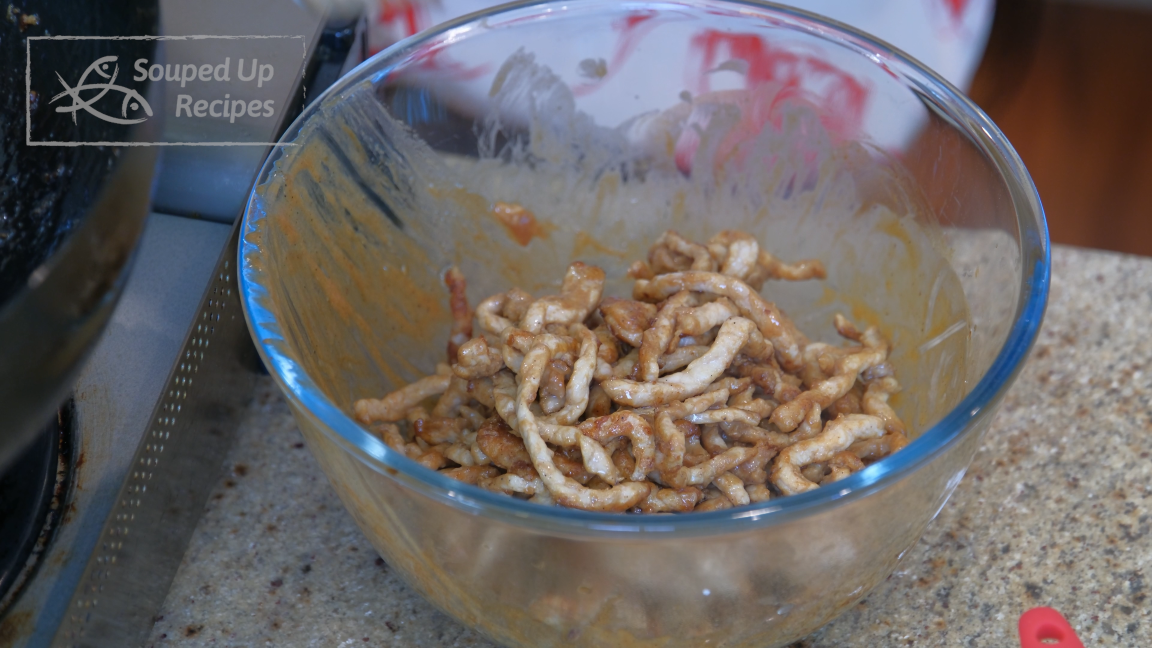 Image of Remove the pork from the wok and set it aside.