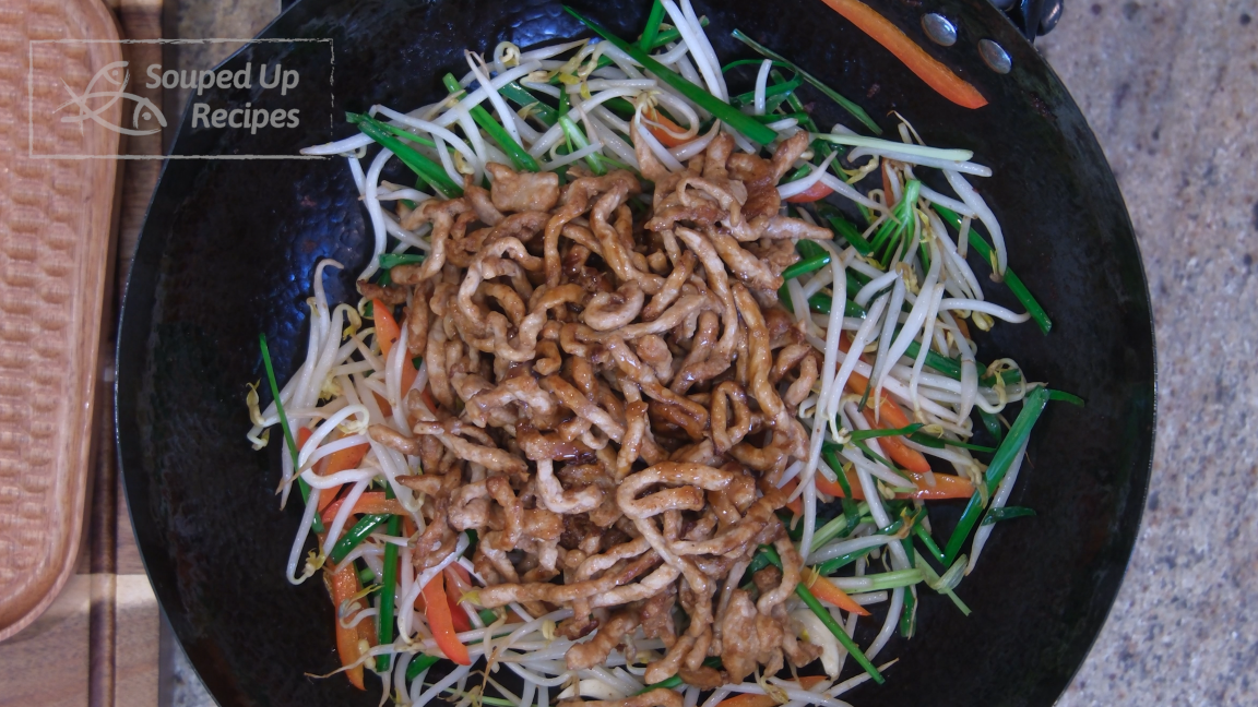 Image of Introduce the pork back to the wok and pour in the seasoning. Keep mixing until well combined. Check the bottom of the dish; it should have no running sauce. That is how you know the bean sprouts are perfectly cooked.