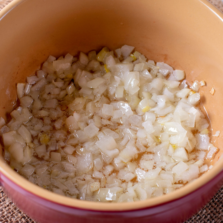 Image of Heat oil in a pot on medium temp then add onion, garlic and ginger. Cook for 1 min or when onion is translucent