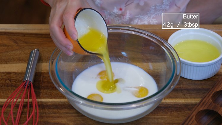 Image of In a mixing bowl, combine the egg yolks, sugar, milk,...
