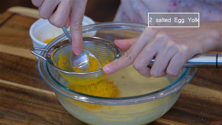 Image of Press the reserved salted egg yolk through the sieve into...