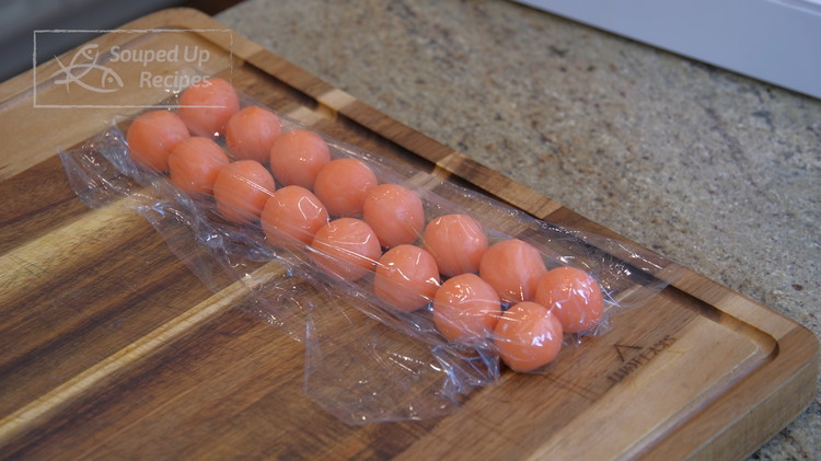 Image of The next day, take the milk yolk custard filling out of the fridge and divide it into 16 even pieces, 18 grams each. Roll each one into a ball. Once done, cover them so they don't dry out.