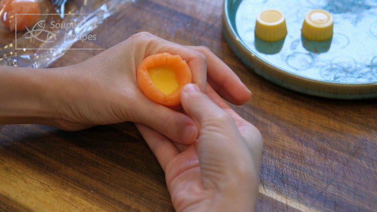 Image of Poke a hole in the middle of the custard filling and use it to wrap the lava filling. Do that to all 16 of them. The frozen filling will get soft as you are working. If you are slow, put...