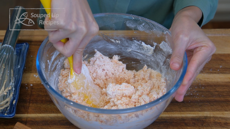 Image of Sieve in the cornstarch and cake flour. Switch to a spatula and mix until you don't see any dry flour. This will take only 2 minutes. Don't over-mix because we don't want the wrapper to be doughy.