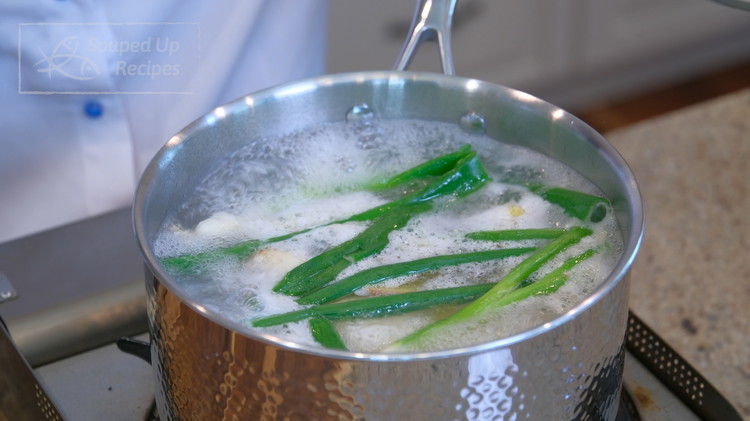 Image of Check back on the chicken leg quarters. It should have come to a boil by now. Turn the heat to low and let it simmer for 8 minutes.
