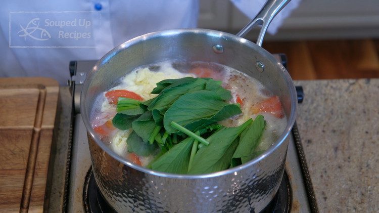 Image of Last, chop a handful of green leafy vegetables into 2-inch stalks and stir them into the broth.