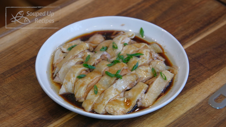 Image of Place the chicken on a serving plate. Drizzle in the scallion sauce all over and garnish with some diced scallions.