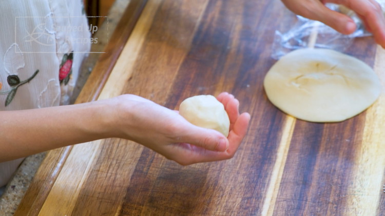 Image of Split the Yousu dough in half. Take one half and roll it into a ball. Use the Shuiyoupi wrapper to wrap the Yousu dough. Once done, cover it with a plastic film let it rest for 15 minutes on the...
