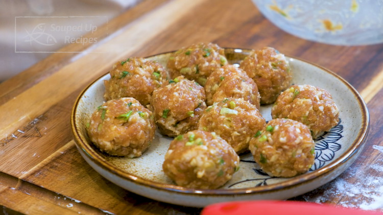 Image of Take the filling out of the fridge. Divide it into 10 even pieces, about 25g each. Roll each one into a ball and set them aside.