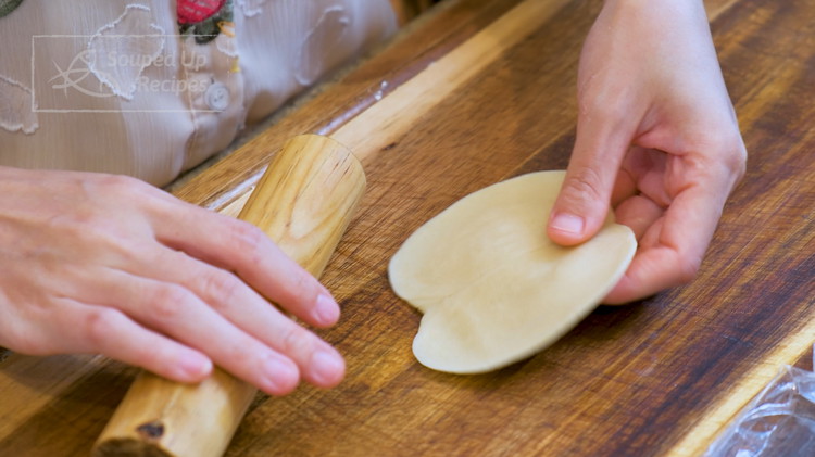 Image of Put a small dough on the working surface. Press the center, bend the dough in half with the cut surface facing up, then flatten it down. Use a rolling to roll it into a 4 inch wrapper. It won’t be...