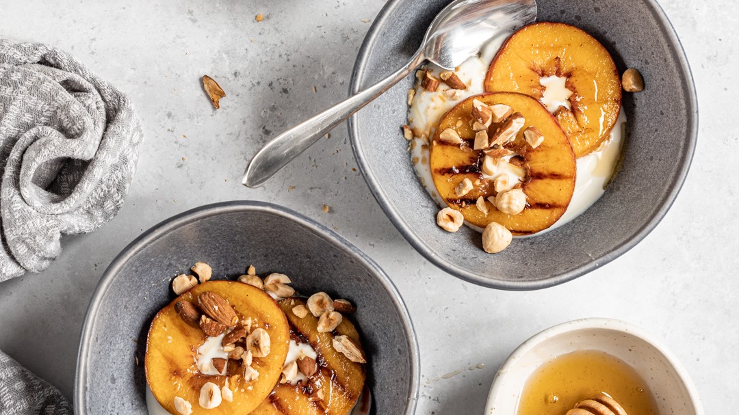 Image of Yoghurt Bowl with Griddled Peaches & Roasted Nuts