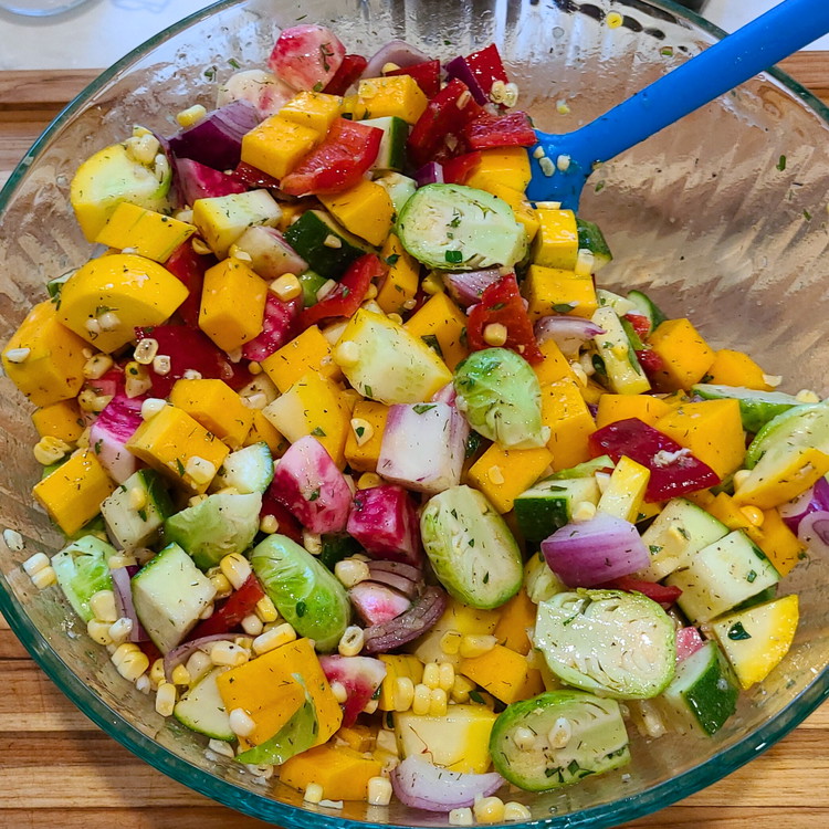 Image of Add in all the chopped vegetables and toss until they're evenly seasoned.