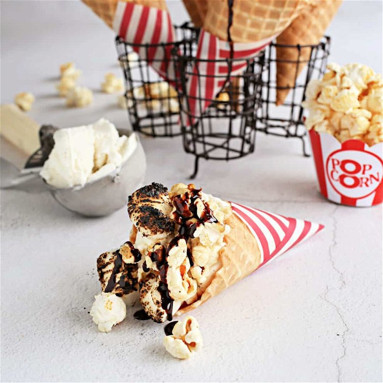 Image of Top each cone with a generous amount of popped corn...