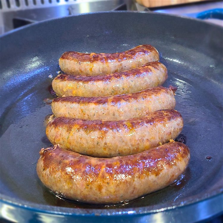 Image of To sear the Bratwurst, add some oil to the skillet,...