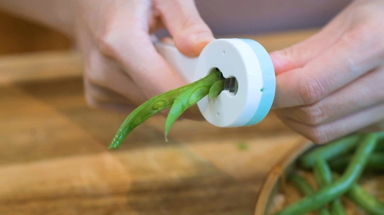 Image of Push all the green beans through the tool and split them in half. If you don't have this tool, cut the green beans open using a knife.