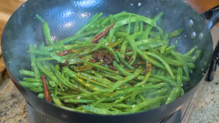 Image of Add the green beans and continue to mix for a couple of minutes. Turn the heat to medium-low and pour in the sauce. Let it cook in that delicious sauce for a few minutes to allow the seasoning to be...