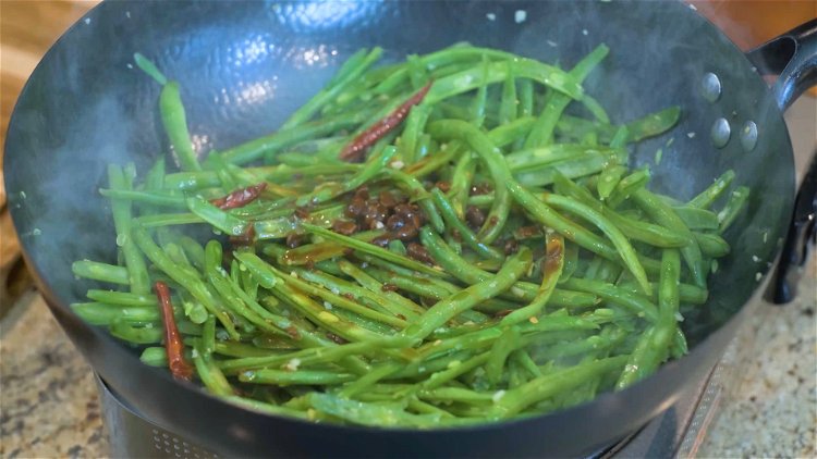 Image of Add the green beans and continue to mix for a...