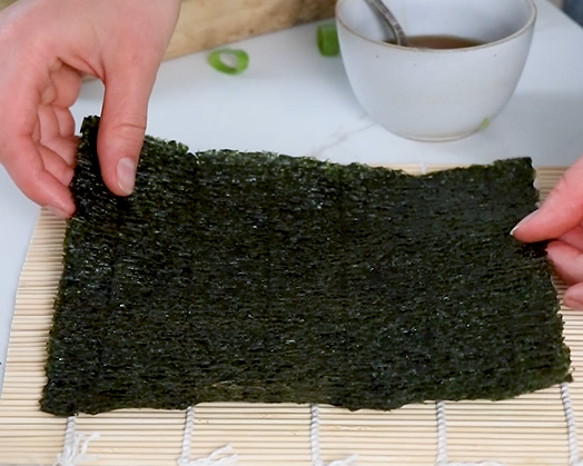 Image of Place a nori seaweed sheet on parchment paper or bamboo...