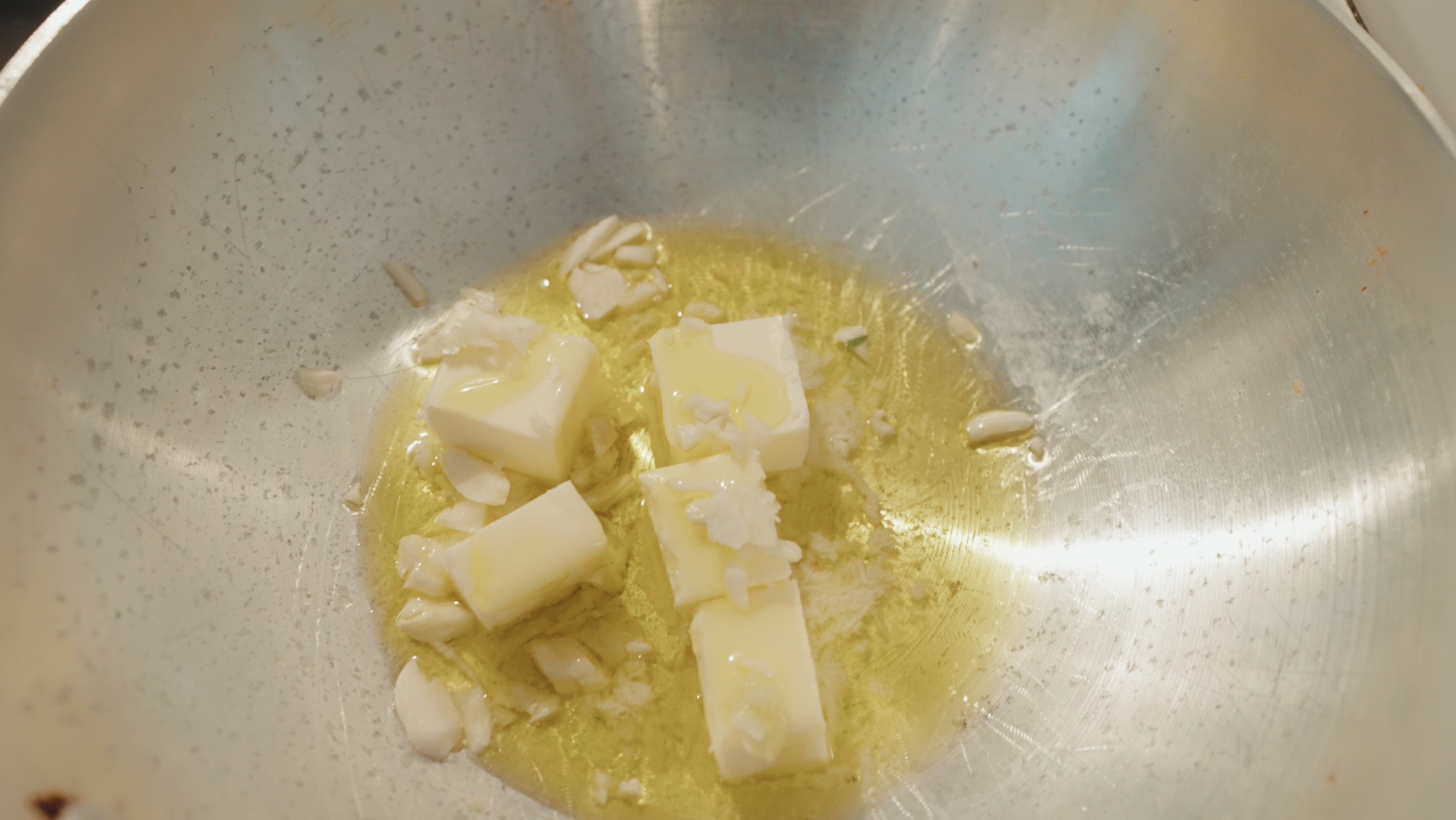 Image of Stir in a stick of butter quartered into your garlic...