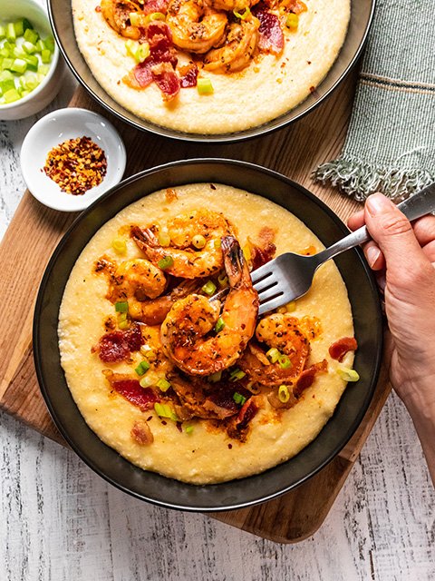 Image of Serve shrimp over grits topped with green onions, pepper flakes...