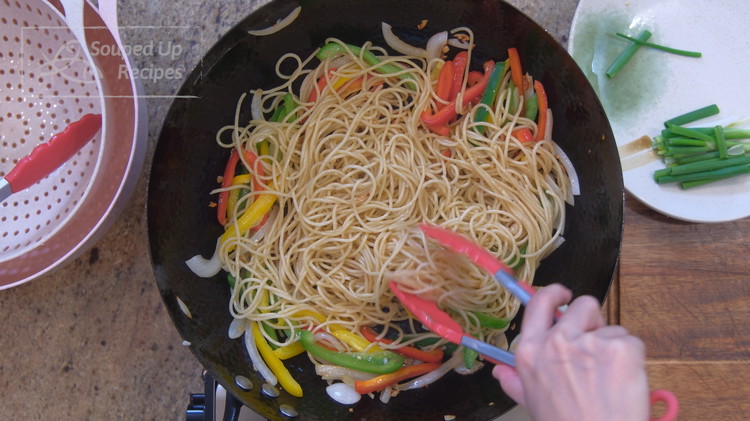 Image of Add the bell pepper along with the spaghetti. Switch to a pair of tongs to stir and fluff the noodles for a couple of minutes.