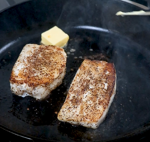Image of Flip the fish filets. Add the remaining butter, minced garlic,...