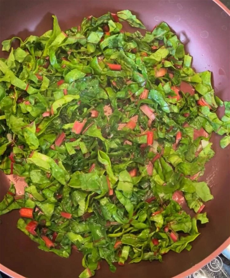 Image of Add swish chard and water, stir and cover pan