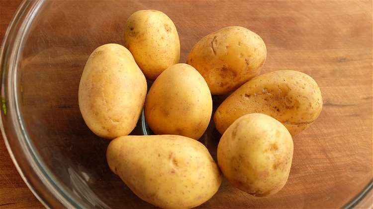 Image of Place your potatoes in a bowl and coat in about...