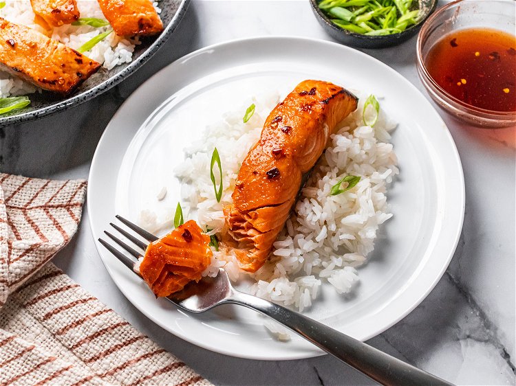 Image of Serve salmon hot over rice with reserved sauce for topping....