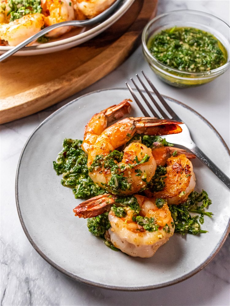 Image of Serve shrimp hot topped with Chimichurri sauce.